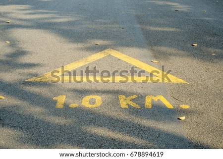 Arrow on the road, yellow color background