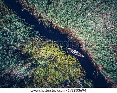Discovering Danube Delta in a Canoe. Aerial view with a drone.