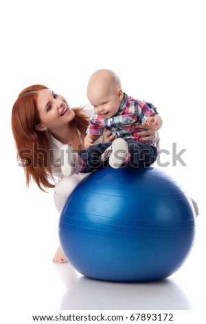 Mother and sweet small baby with fitness ball on a white background.