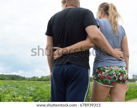 Lovers man and woman hugging on a grass background.