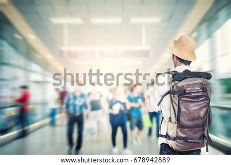 Young traveller with backpack and straw hat looking travel goals.