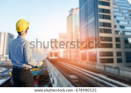 Close up engineers working on a building site holding a blueprints.Engineering and architecture concept Royalty-Free Stock Photo #678980125
