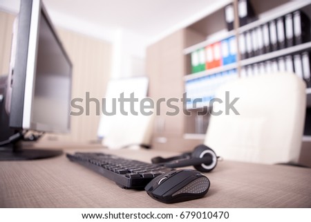 Close up of keyboard, mouse and headset on office table. Modern interior design