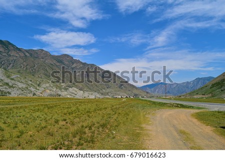 Chuya Highway (R256, M52) and dirt road in Altai mountains. Altay Republic, Siberia, Russia.