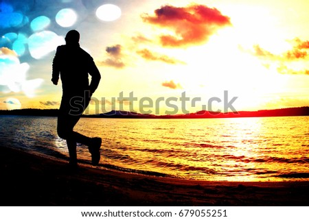 Film grain effect. Silhouette of sport active man running and exercising on the beach at sunset.