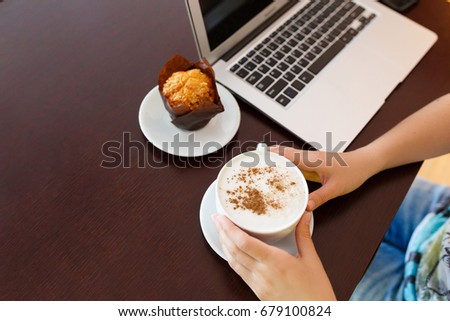 Coffee cup , maffine and laptop in coffee shop. Networking and occupation concept