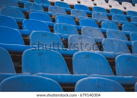 Rusty plastic blue and white stadium seats