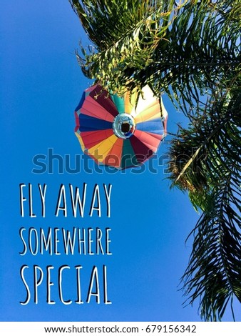 Fly Away Somewhere Special typography design on hot air balloon background image.