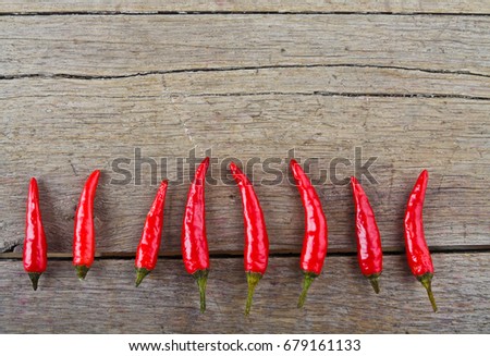 Red hot chili peppers on old wooden table