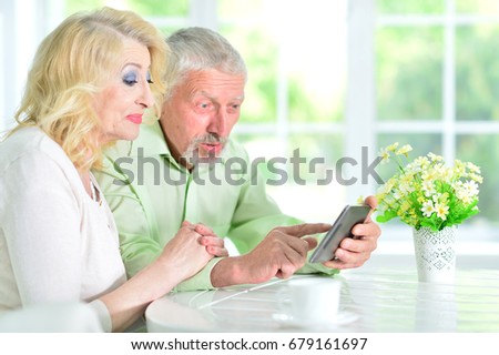 senior couple using tablet