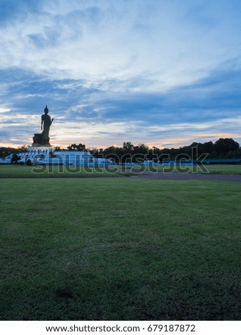 Silhouette of The Posture of walking Buddhist Statue in Sunset