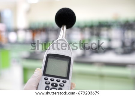 Measuring the noise in laboratory room with a sound level meter.                                Royalty-Free Stock Photo #679203679