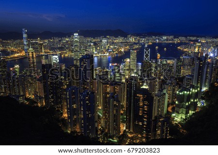 Hong Kong City Skyline at night time, photo taken from a nearby mountain (Victoria Peak) overlooking the city. Famous Tourist Destinations of Asia, Futuristic Cityscapes of Asia.