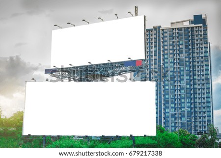 Billboards in front of tall buildings.