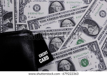 Credit Card in black wallet on us dollar background