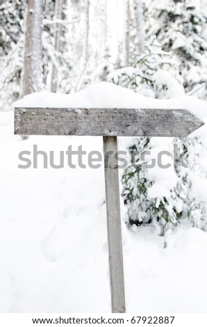 an empty sign in a winter setting. (Put in your own text)