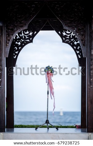 a flower stand for wedding ceremony nearby the sea