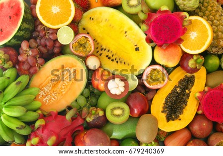 Tropical fruits background, many colorful ripe tropical fruits  Royalty-Free Stock Photo #679240369