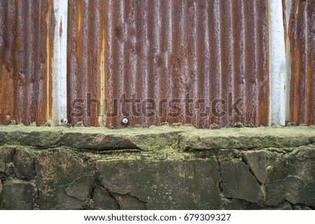 Stone with moss fence and corrugated rusty zinc wall or fence for writing wallpaper background.