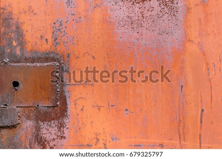 Red painted surface of metal sheet with traces of rust. Abstract background