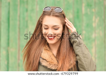 Beautiful young woman with bright on color background