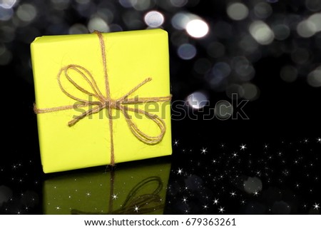 beautiful packaged gift yellow on a black background