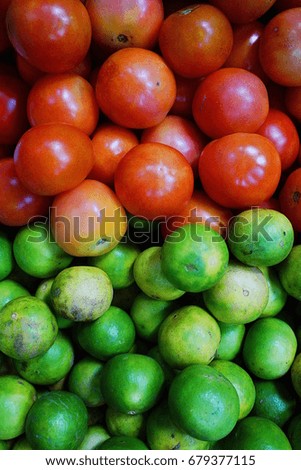 Contrast color between tomato and lime fruit. Royalty-Free Stock Photo #679377115