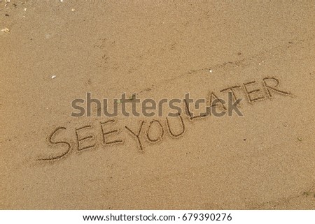 Handwriting  words "SEE YOU LATER" on sand of beach.