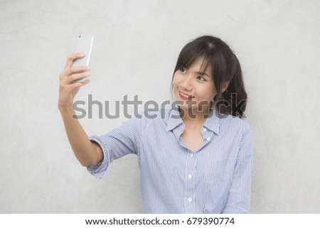 Beautiful young asian woman using smartphone for selfie, 20s year old.