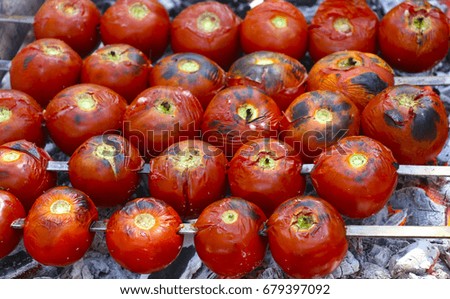 Fried tomato on a brazier