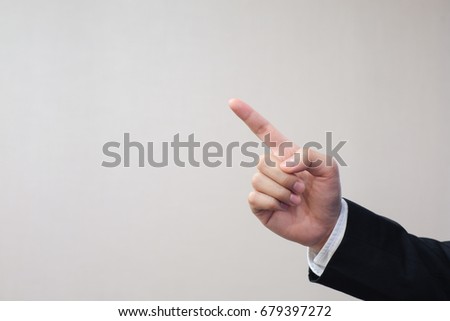 close up businessman hand pointing on bright color background,copyspace for your text or ads,business concept