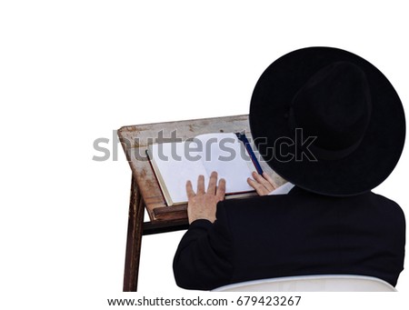 An ultra-orthodox Jewish man reads a book - isolated Royalty-Free Stock Photo #679423267