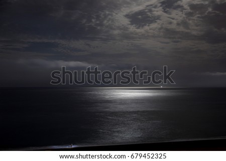 Night sky with moonlight clouds and sea