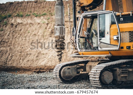 Construction site, highway building with industrial rotary drilling machinery close up Royalty-Free Stock Photo #679457674