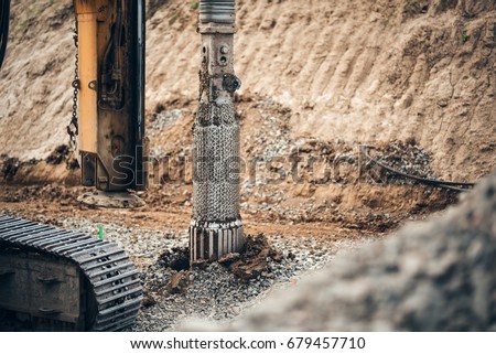 heavy duty machinery used for drilling holes in the ground on construction site. Highway building details with rotary drilling machine  Royalty-Free Stock Photo #679457710