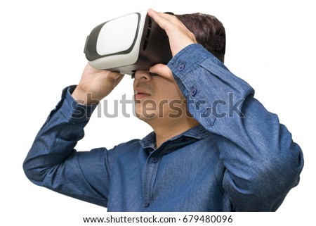 Young man using virtual reality goggles (VR) on white background.