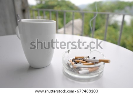 Coffee and cigarette break Royalty-Free Stock Photo #679488100