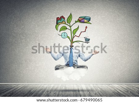 Businessman in lotus pose with lamp head meditating on cloud