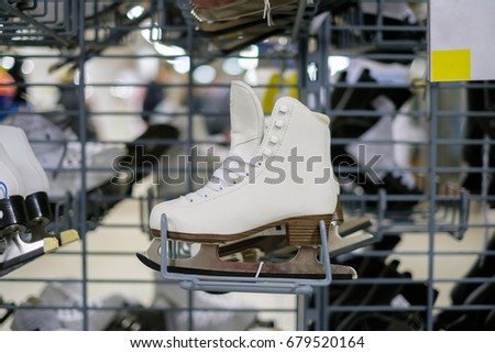 Classic ice skating boots on hangers in outdoor sports store