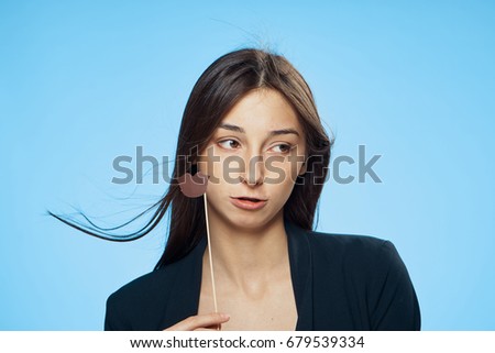 Woman with paper accessory on blue background portrait                               
