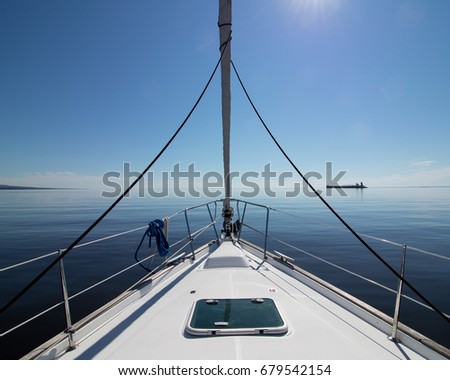 Peaceful sailboat on calm water in Lake Superior Royalty-Free Stock Photo #679542154