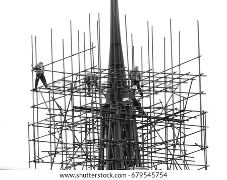 Workers on the scaffolding are building a pagoda black and white style