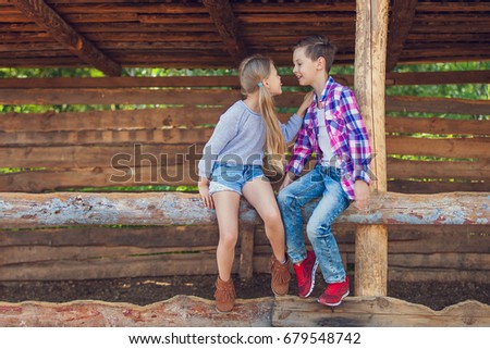 Adorable happy kids, boy and girl together playing in country farm