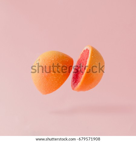 Grapefruit sliced on pastel pink background. Minimal fruit concept.