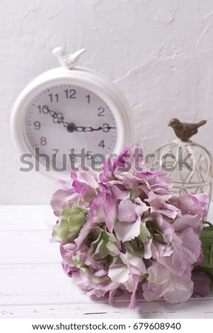 Postcard with pink hydrangea flowers and clock on light textured background. Shabby chic.  Vertical image.