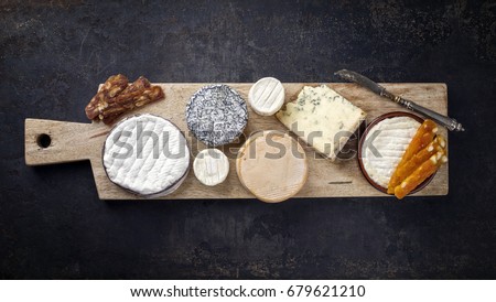 French Cheese Platter with Spanish Dulce de Membrillo as top view on a wooden board Royalty-Free Stock Photo #679621210