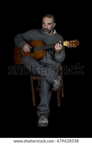 guitarist playing his instrument on black background