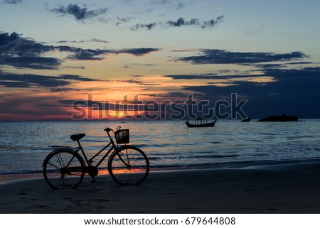 Bicycle on beach at sunset. Ngapoli Myanmar Burma