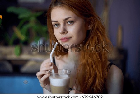 Woman with latte in cafe                               