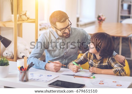Delighted positive man looking at his son Royalty-Free Stock Photo #679651510